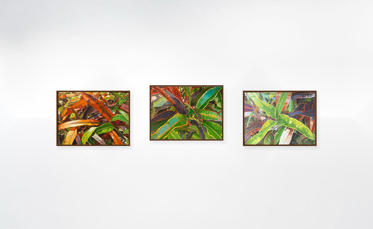Croton Nature Series oil paintings by John Gurbacs at Marcolina's Gallery Tampa. A three-piece framed wall art set featuring colorful painted tropical leaves, displayed side-by-side on a clean white wall.