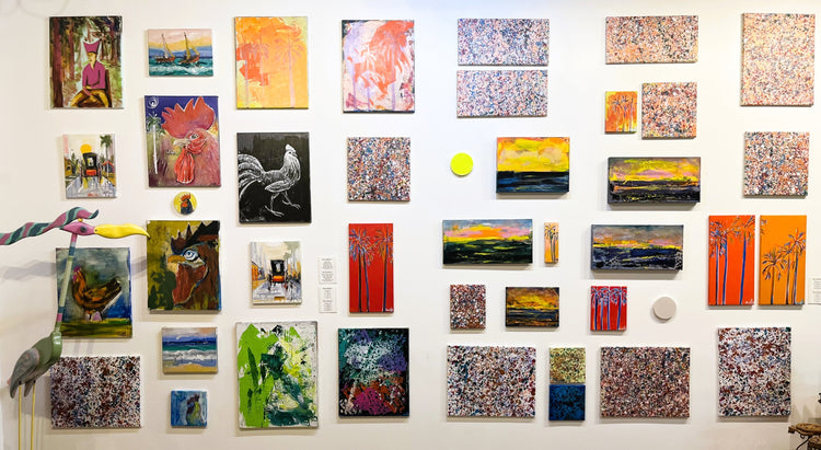 Gallery wall of different styles of artwork.