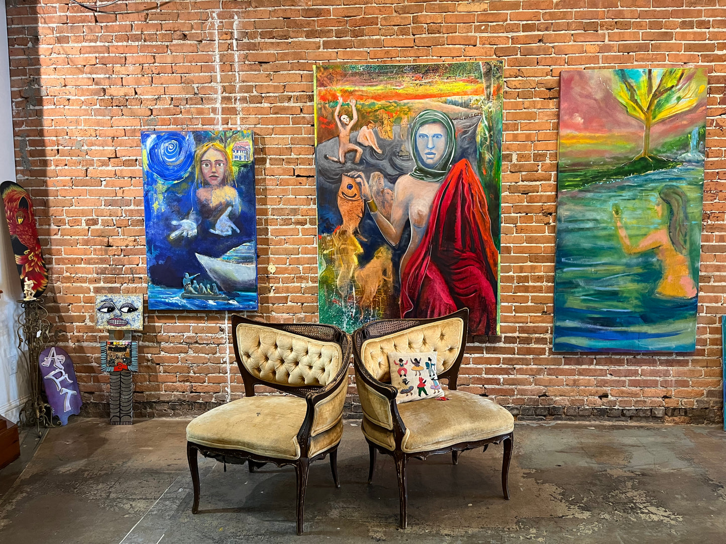 Three Guillo Perez III paintings, from left to right: "Hope", "The Return of Abudance", "Missing Paradise".