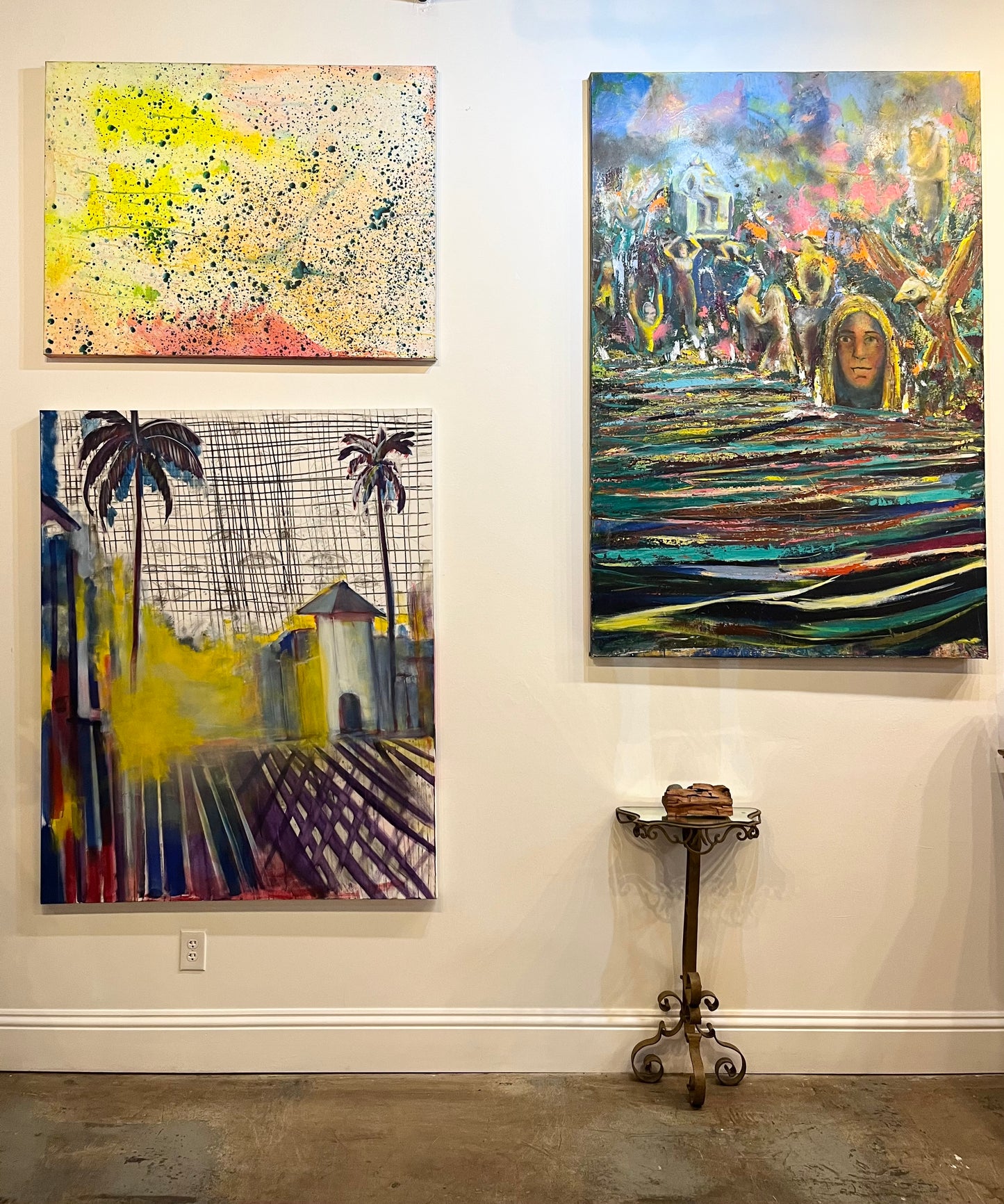 Ybor City III a mixed media painting with other paintings by Guillo Perez III over a white wall.